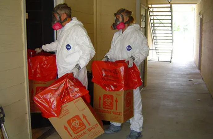 two biohazard technicians with biohazard red bags - Ranger Recovery