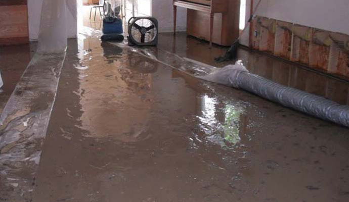flooded floor with fan and water extraction equipment