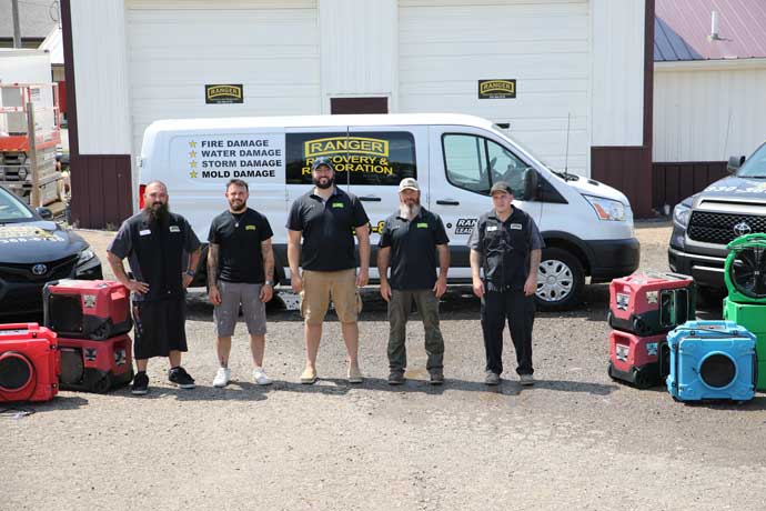 the Ranger Recovery crew standing in front of their van