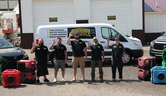 Ranger Recovery Crew standing in front of their van